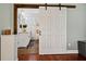 Bedroom featuring a sliding barn door to the bathroom, wooden accents and neutral tones at 1558 Line St, Decatur, GA 30032