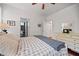 Bright bedroom with a bed, gray blanket, white dresser, and bathroom entrance at 1558 Line St, Decatur, GA 30032