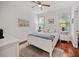 Comfortable bedroom with a bed, matching nightstands, and hardwood flooring at 1558 Line St, Decatur, GA 30032