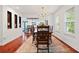 Lovely dining area with hardwood floors, a patterned rug, and a modern chandelier over the dining table at 1558 Line St, Decatur, GA 30032