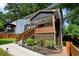Charming home featuring a cozy front porch with wooden railing and landscaped garden at 1558 Line St, Decatur, GA 30032