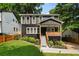 Charming two-story home with a welcoming front porch, landscaped yard, and freshly cut lawn at 1558 Line St, Decatur, GA 30032