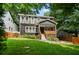 Charming home boasts manicured landscaping, a welcoming front porch, and dark exterior at 1558 Line St, Decatur, GA 30032