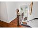 Hallway features wood floors, iron railing, and view of the staircase at 1558 Line St, Decatur, GA 30032