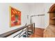 Hallway features wood floors, iron railing, barn door and view of chandelier at 1558 Line St, Decatur, GA 30032