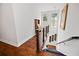 Hallway with wood floors leading to stairs with decorative elements at 1558 Line St, Decatur, GA 30032