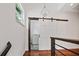 Hallway features wood floors, iron railing and barn door access to laundry at 1558 Line St, Decatur, GA 30032