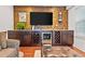 Living room features built-in cabinetry with a wine fridge and wood accent wall at 1558 Line St, Decatur, GA 30032