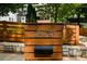 Stylish home address on a wood post, complemented by a wood fence and stone base at 1558 Line St, Decatur, GA 30032