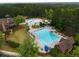 Aerial view highlighting resort-style pool, splashpad, slide, and clubhouse, providing opportunities for recreation and relaxation at 1604 Falcon Ct, Locust Grove, GA 30248