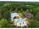 Aerial view showcasing a resort-style pool, splashpad and clubhouse, creating a luxurious and entertaining atmosphere at 1604 Falcon Ct, Locust Grove, GA 30248