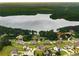 Aerial view showcases a neighborhood with homes nestled around a serene lake at 1604 Falcon Ct, Locust Grove, GA 30248
