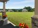 Spacious backyard with green lawn, trees, and a covered patio at 1604 Falcon Ct, Locust Grove, GA 30248
