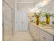 This bathroom features a double vanity with granite counters, tile floors and walk-in shower with glass door at 1604 Falcon Ct, Locust Grove, GA 30248