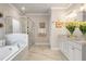 Bright bathroom with modern shower, soaker tub, dual vanity with granite counters, and stylish decor at 1604 Falcon Ct, Locust Grove, GA 30248