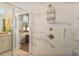 This bathroom features a walk-in shower with glass door, marble tile, and bronze fixtures at 1604 Falcon Ct, Locust Grove, GA 30248
