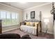 Comfortable bedroom featuring daybed, carpet, and window with plantation shutters at 1604 Falcon Ct, Locust Grove, GA 30248