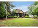 Exterior of a building with well-manicured lawn and mature trees creating a serene landscape at 1604 Falcon Ct, Locust Grove, GA 30248