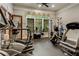 Spacious fitness center is equipped with various machines and floor-to-ceiling windows providing natural light at 1604 Falcon Ct, Locust Grove, GA 30248