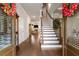 Inviting entryway with hardwood floors, staircase, and views into the living room at 1604 Falcon Ct, Locust Grove, GA 30248
