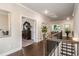 Bright hallway with wood floors, trim, wrought iron stair railing and views to other rooms at 1604 Falcon Ct, Locust Grove, GA 30248