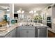 Granite countertops complement the stainless steel appliances and cabinetry in this beautifully appointed kitchen at 1604 Falcon Ct, Locust Grove, GA 30248