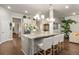 Bright kitchen boasts a large center island with seating, granite countertops and stainless steel appliances at 1604 Falcon Ct, Locust Grove, GA 30248