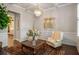Cozy living room featuring a coffered ceiling, chandelier, and wainscoting at 1604 Falcon Ct, Locust Grove, GA 30248