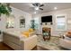 Comfortable living room features a fireplace, large windows, and stylish decor at 1604 Falcon Ct, Locust Grove, GA 30248