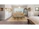 Spacious main bedroom featuring a sitting area with a large sofa, decorative mirrors, and a crystal chandelier at 1604 Falcon Ct, Locust Grove, GA 30248