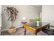 Neutral office features a faux tree, glass-topped desk, and decorative lamp at 1604 Falcon Ct, Locust Grove, GA 30248