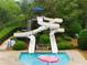 Community pool featuring a thrilling twisting water slide, surrounded by lush landscaping for a resort-like atmosphere at 1604 Falcon Ct, Locust Grove, GA 30248