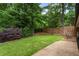 Manicured backyard with healthy green grass, lush bushes, and a hammock for outdoor relaxation at 3042 Argonne Dr, Atlanta, GA 30305