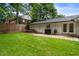 Spacious backyard with lush lawn, outdoor seating, grill, and fenced perimeter at 3042 Argonne Dr, Atlanta, GA 30305
