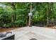 Spacious backyard area featuring basketball hoop, trampoline and lush surrounding greenery at 3042 Argonne Dr, Atlanta, GA 30305