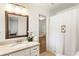 Bright bathroom featuring granite countertops, framed mirror, and shower with decorative curtain at 3042 Argonne Dr, Atlanta, GA 30305