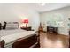Well-lit bedroom with hardwood floors, a wooden bed frame, and bright window at 3042 Argonne Dr, Atlanta, GA 30305