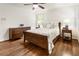 Well-lit bedroom featuring hardwood floors, a comfortable bed, matching nightstands, and ample natural light at 3042 Argonne Dr, Atlanta, GA 30305
