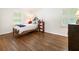 Cozy bedroom with hardwood floors, neutral walls, and abundant natural light through shuttered windows at 3042 Argonne Dr, Atlanta, GA 30305
