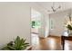Inviting entryway with hardwood floors, stylish lighting fixture, and a view into the living room at 3042 Argonne Dr, Atlanta, GA 30305