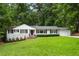 Charming brick home with black shutters, manicured lawn, and professional landscaping at 3042 Argonne Dr, Atlanta, GA 30305