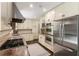 Modern kitchen with stainless steel appliances, gas range, granite counters, and ample cabinet space at 3042 Argonne Dr, Atlanta, GA 30305