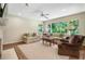 Bright and airy living room with large windows offering beautiful views, comfortable seating, and a ceiling fan at 3042 Argonne Dr, Atlanta, GA 30305