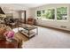 Inviting living room featuring hardwood floors, neutral tones, and large windows with neighborhood views at 3042 Argonne Dr, Atlanta, GA 30305