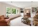 Cozy living room with neutral carpet, large window, and built-in shelving, great for relaxation at 3042 Argonne Dr, Atlanta, GA 30305