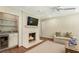 Cozy living room featuring a brick fireplace with mounted TV, built-in bar, and comfortable seating at 3042 Argonne Dr, Atlanta, GA 30305