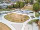 Aerial view of community park featuring pathways, lawn area, stage and seating and lush landscaping at 834 Timberland Se St, Smyrna, GA 30080