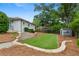 Expansive backyard featuring an artificial lawn, hardscape elements, and surrounding greenery, ideal for recreation at 834 Timberland Se St, Smyrna, GA 30080