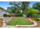 Scenic backyard view showcasing a lush lawn, storage shed, and manicured landscaping, perfect for outdoor activities at 834 Timberland Se St, Smyrna, GA 30080