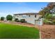 Large backyard featuring an artificial turf area, retaining wall, and exterior view of the home at 834 Timberland Se St, Smyrna, GA 30080